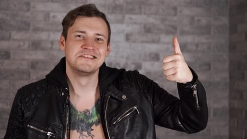 Young Adult Gives Thumbs Up With Funny Expression