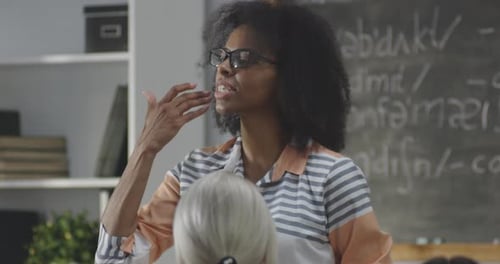 Teacher Talking in Front of a Classroom