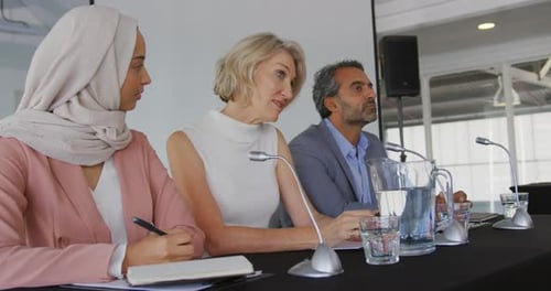 Panelists At Corporate Conference Speaking and Listening