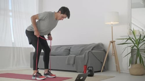 Man Doing Resistance Band Workout at Home