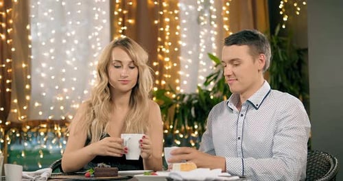 Couple Enjoying Drinks Together at Restaurant Table