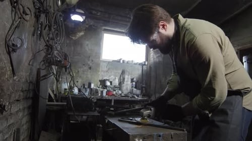 Artisan Grinding Metal in Rustic Workshop