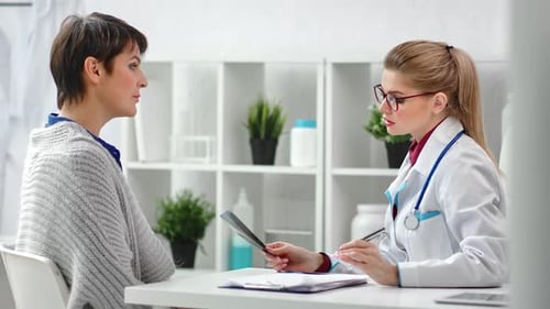 Doctor Explains X-Ray to Patient in Office