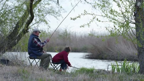 Elderly Male Fisherman and His Beloved Grandson Caught Small Fish with Fishing Rod in Pond