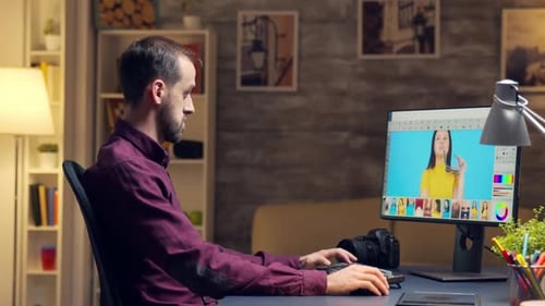 Graphic Designer Editing Photos at Desk Indoors