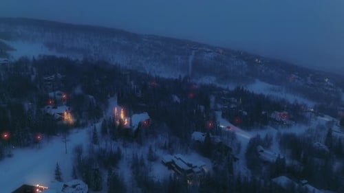 Aerial View of the Night Alpine Town with Ski Slopes and Complex