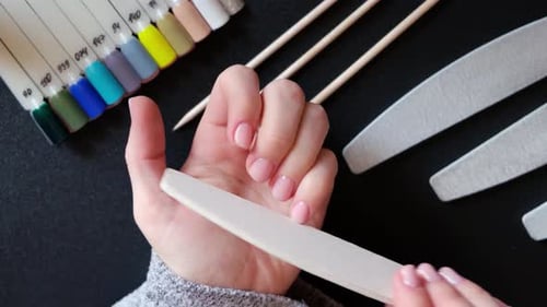 Woman filing her nails, overhead shot