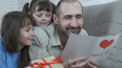 Father Receives Birthday Card from Daughters
