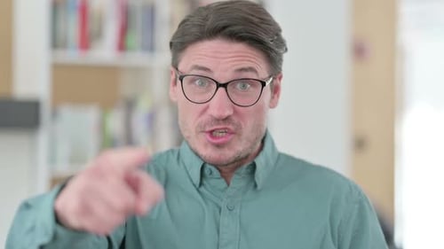 Adult Man Speaking and Pointing Index Finger