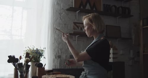 Woman Woodworker Carving Small Wooden Art Piece