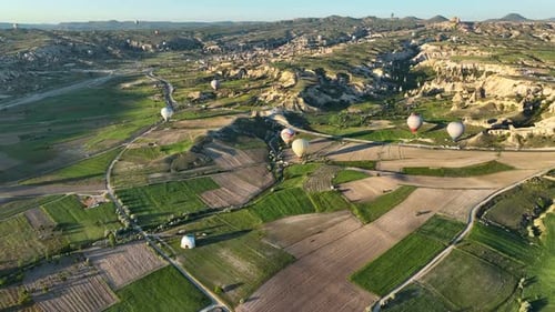 4K Aerial view of Goreme. Colorful hot air balloons fly over the valleys.