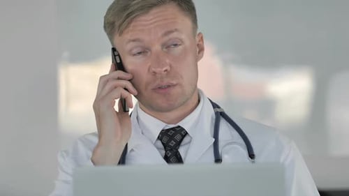 Doctor On Phone In Office Close Up