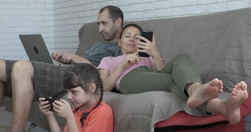 Family Relaxing at Home with Technology