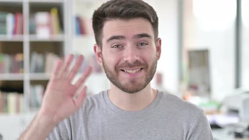 Man Smiles and Waves in Friendly Close Up