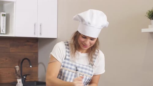 Woman Mixing Ingredients in Bowl in Kitchen