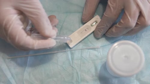 The doctor makes a rapid PCR test for the antigen of the covid-19 virus.