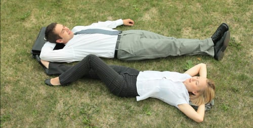 Relaxed Office Workers Taking a Break on Grass