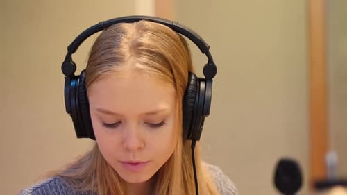 Woman Playing Drums in a Recording Studio