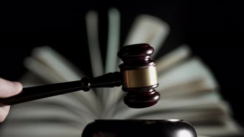 Judge is Hitting Gavel Off a Block in Courtroom