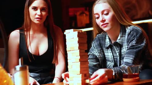 Young People Have Fun Playing Board Games at a Table in Cafe