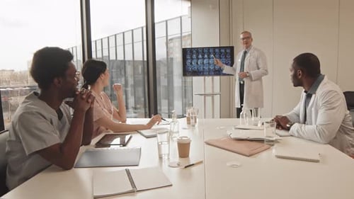 Medical Professionals Analyzing Brain Scans in Conference Room