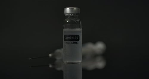 Covid 19-Impfstoffinjektion auf die reflektierende Oberfläche