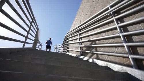 Man Running Down Urban Concrete Steps
