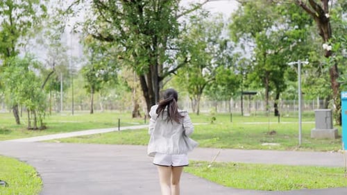 4K Asian woman jogging exercise at public park in the morning