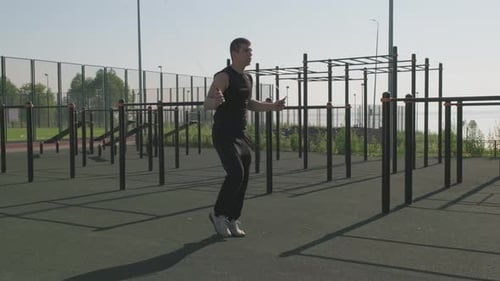 Young Adult Man Jumps Rope in Urban Park