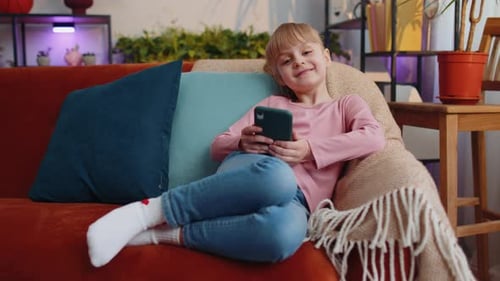 Child Relaxing at Home Using a Smartphone