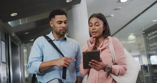 Coworkers Talking at the Office Looking at Tablet