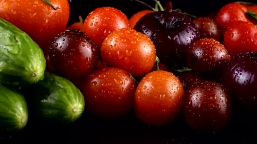 Fresh Cucumbers and Tomatoes with Water Droplets