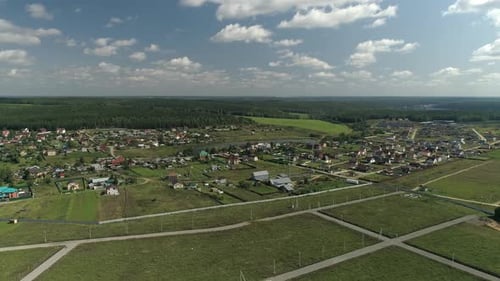 Aerial view of village with pond located among fields and forests 16
