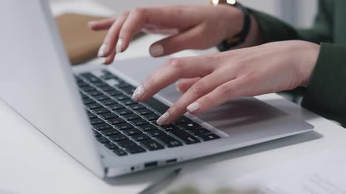 Female Hands Typing on a Laptop Keyboard