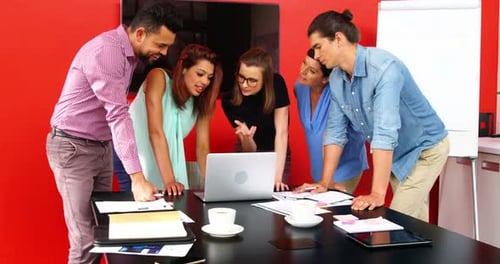 Team Collaborates on Project in Bright Office