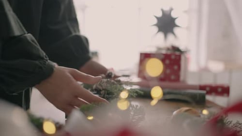 The Hands of a Young Woman Move a Packaged Gift on the Table and Pass It to the Buyer