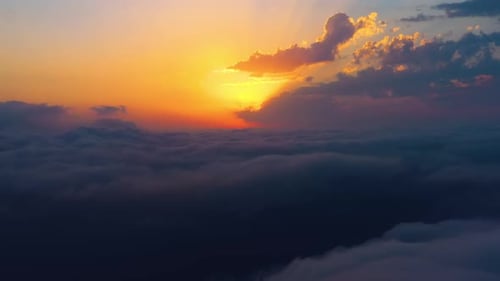 Vibrant Sunrise Above the Clouds Aerial View