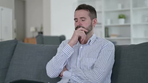 Pensive Young Man Thinking at Home
