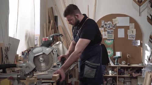 A Male Carpenter Works in a Carpentry Studio