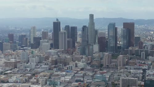 AERIAL: Slowly Circling Downtown Los Angeles Skyline with Warehouse Art District in Foreground with