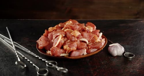 Raw Pork Kebeb on a Plate with Spices Slowly Rotating.
