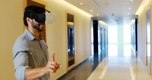 Man Wearing VR Headset Interacting in Hallway