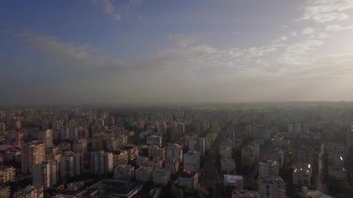 Aerial View of Dense Cityscape Under Blue Sky