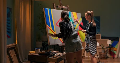 Friends of Artist Spend Time Together in Painting Studio Create a Painting on Canvas Using
