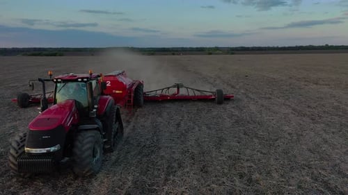 High Angle View of a Tractor Plowing the Field and Planting Seeds Farming