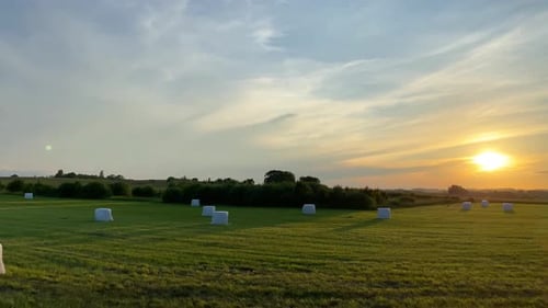 Hay Bales in Field at Colorful Sunset