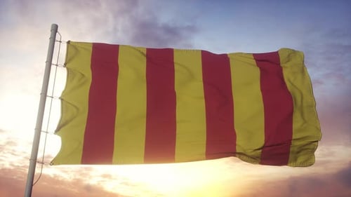 Red and Yellow Striped Flag Waving Against a Sunset Sky