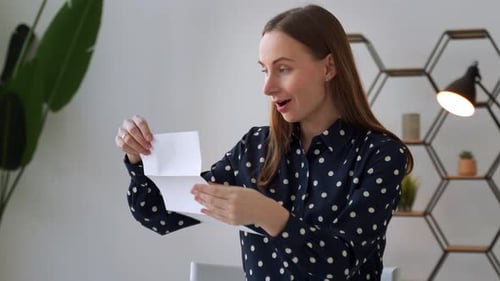 Woman Reacts to Good News in Letter