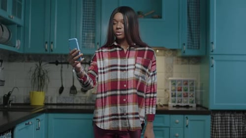 Woman Talking on Video Call in Modern Kitchen