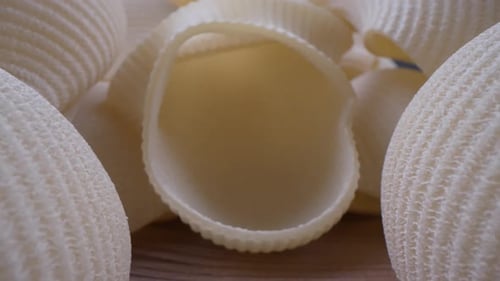 Uncooked Shell Pasta on Wooden Surface